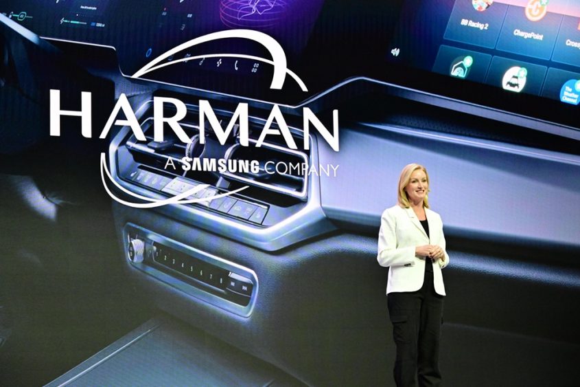 A person standing in front of a large screen

Description automatically generated